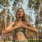 cute blonde woman practising yoga outside looking relaxed 1 1